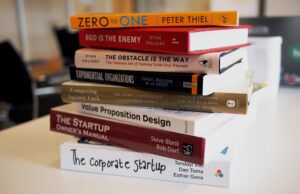 A stack of productivity books on a table.